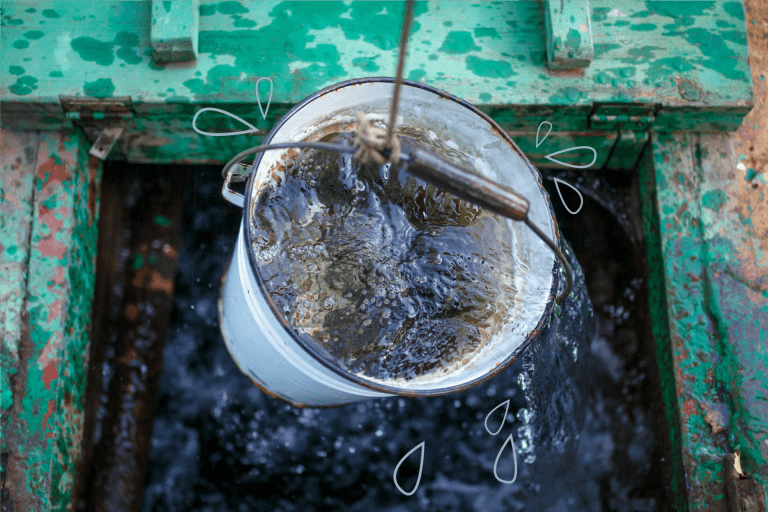 Clean and clear rainwater in a bucket is raised from a well (ovbelov / Shutterstock)