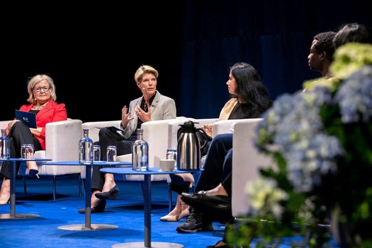 Karin Gardes sitting on Centre Stage at World Water Week 2023, speaking.