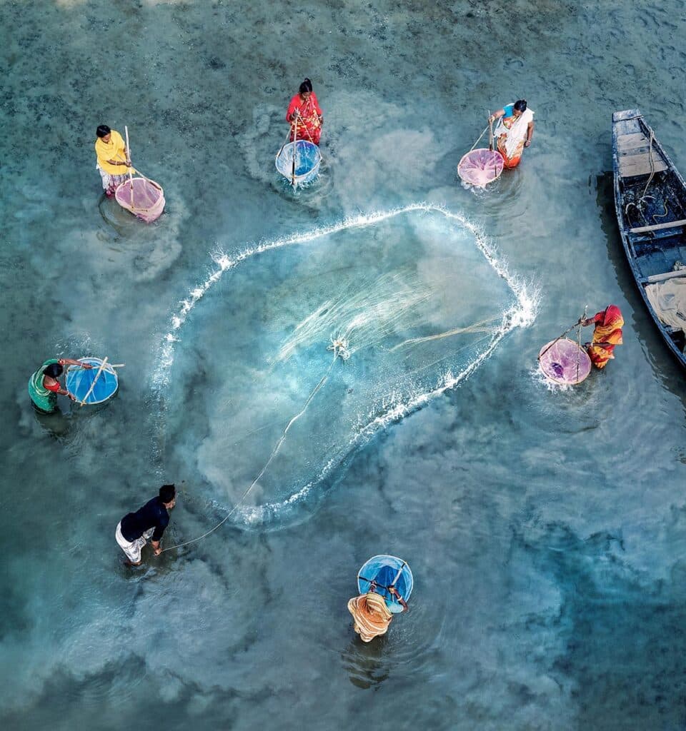 Women fishing in Matla River, West Bengal, India.