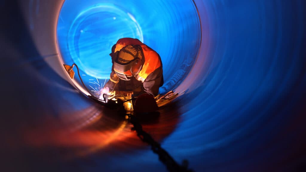 Welding a circular water pipe from the inside.