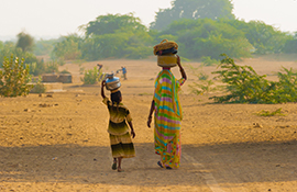 A women and a girl carrying water