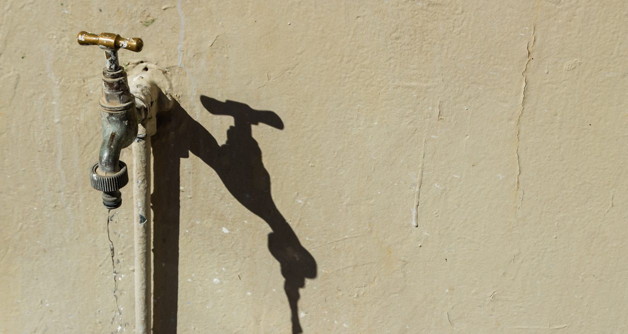 A background image of a running tap and it's shadow