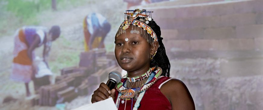 Woman from Kenya dressed in traditional clothes speaking at World Water Week