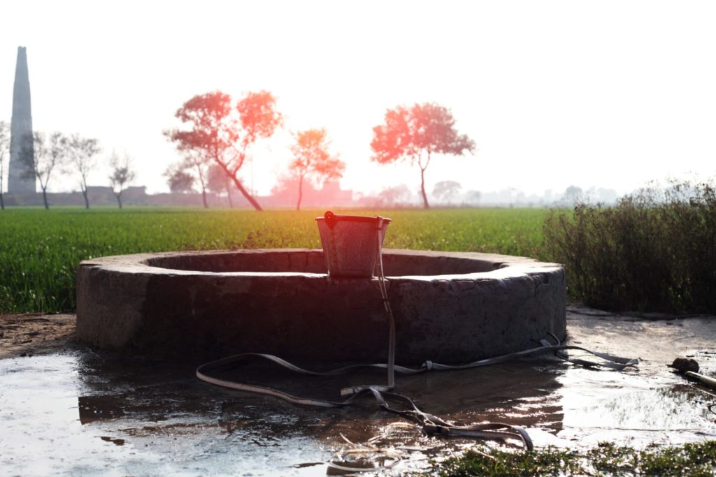 Water well in green field