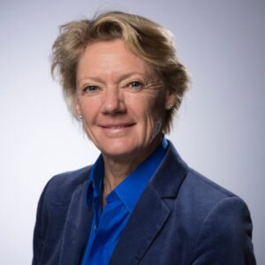 Portrait of Ulla Hamilton, SIWI Board member. White woman with short blond hair, wearing a light blue shirt and dark blue jacket