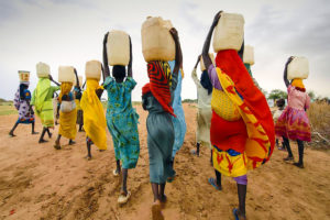 Women carrying water on their heads, near the city of Tanzania, Dar Es Salaam.