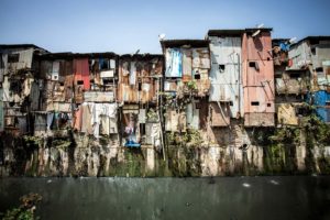 Dharavi slums on a river bank, Mumbai.