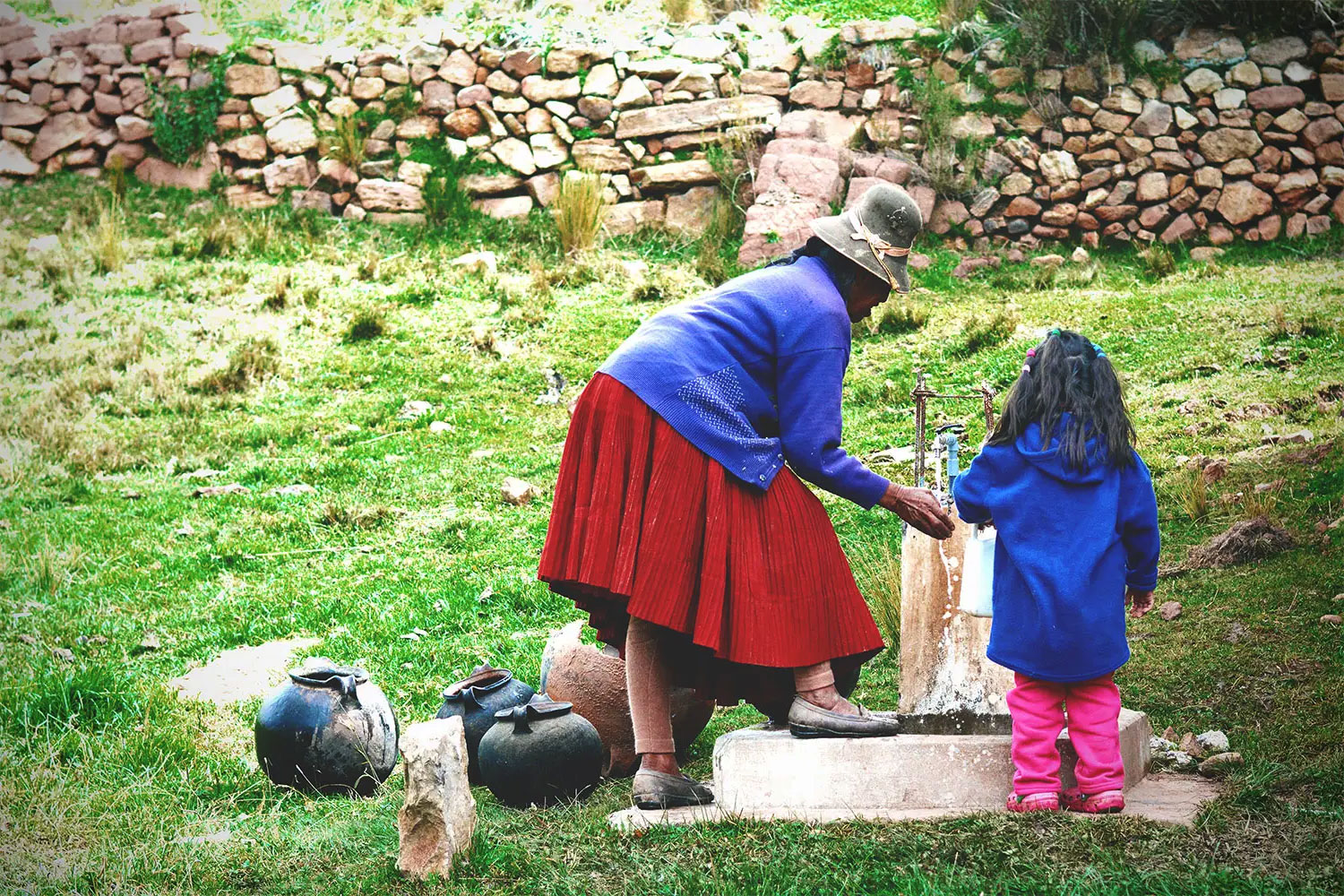Daily filling of jugs from communal tap in rural Peru.