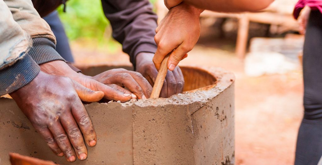 Hands cooperating on building a well