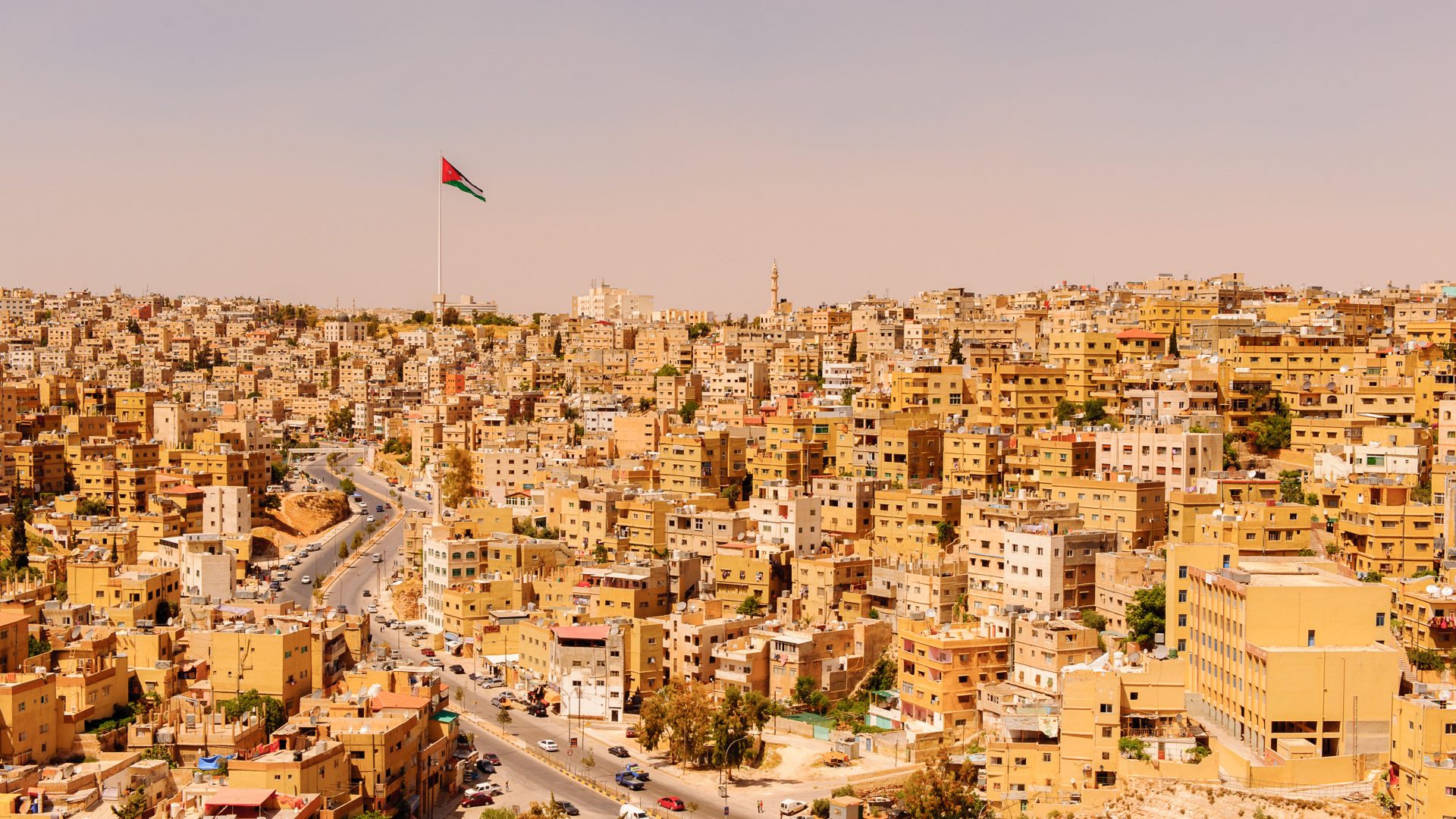 A view of Amman city, with the Jordanian flag