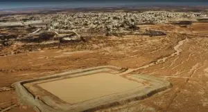 A new water harvesting structure in Azraq water basin of Jordan, made from surrounding mud, is seaml