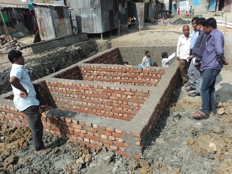 People constructing rainwater harvesting system in Bauniabad community, Bangladesh