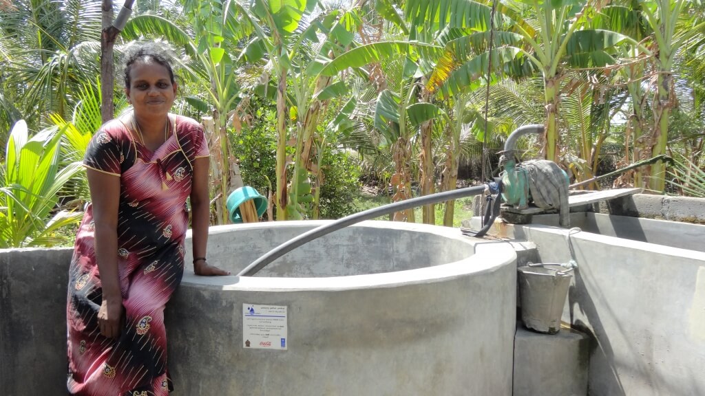 Woman standing beside a wells near the resettled areas of Kadadkaraichenai and Kumpurupity East in Sri Lanka.