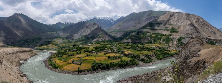 Panorama wild Pyandzh River and Valley with high mountains at Vilojati in Tajikistan with Afghanistan at the other site of the river.