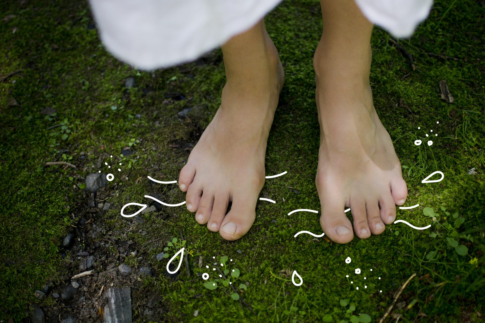 Pair of feet standing on moss