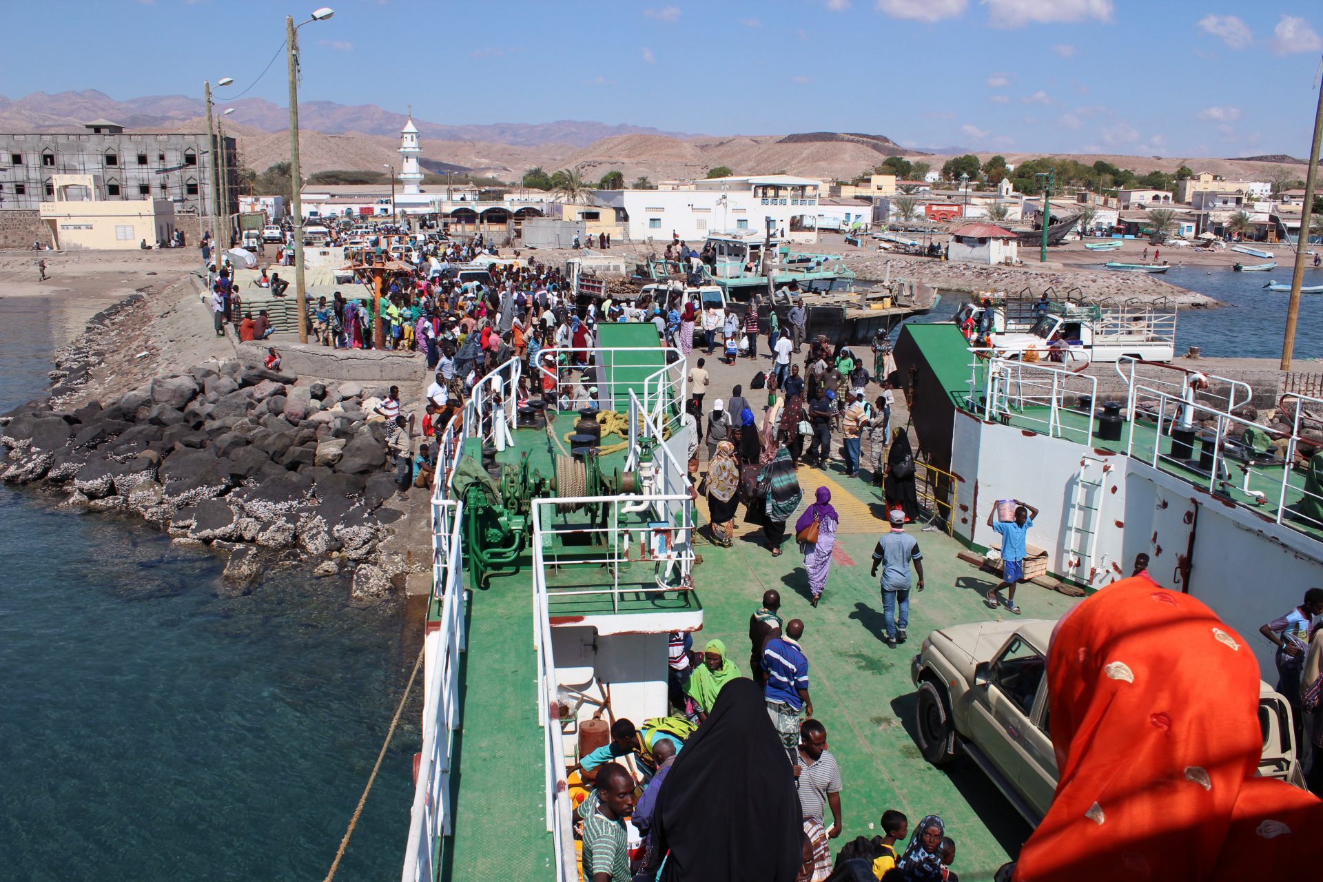 Tadjoura, DA colourful crowd of people spills off the ferry as it reaches the port of Tadjoura