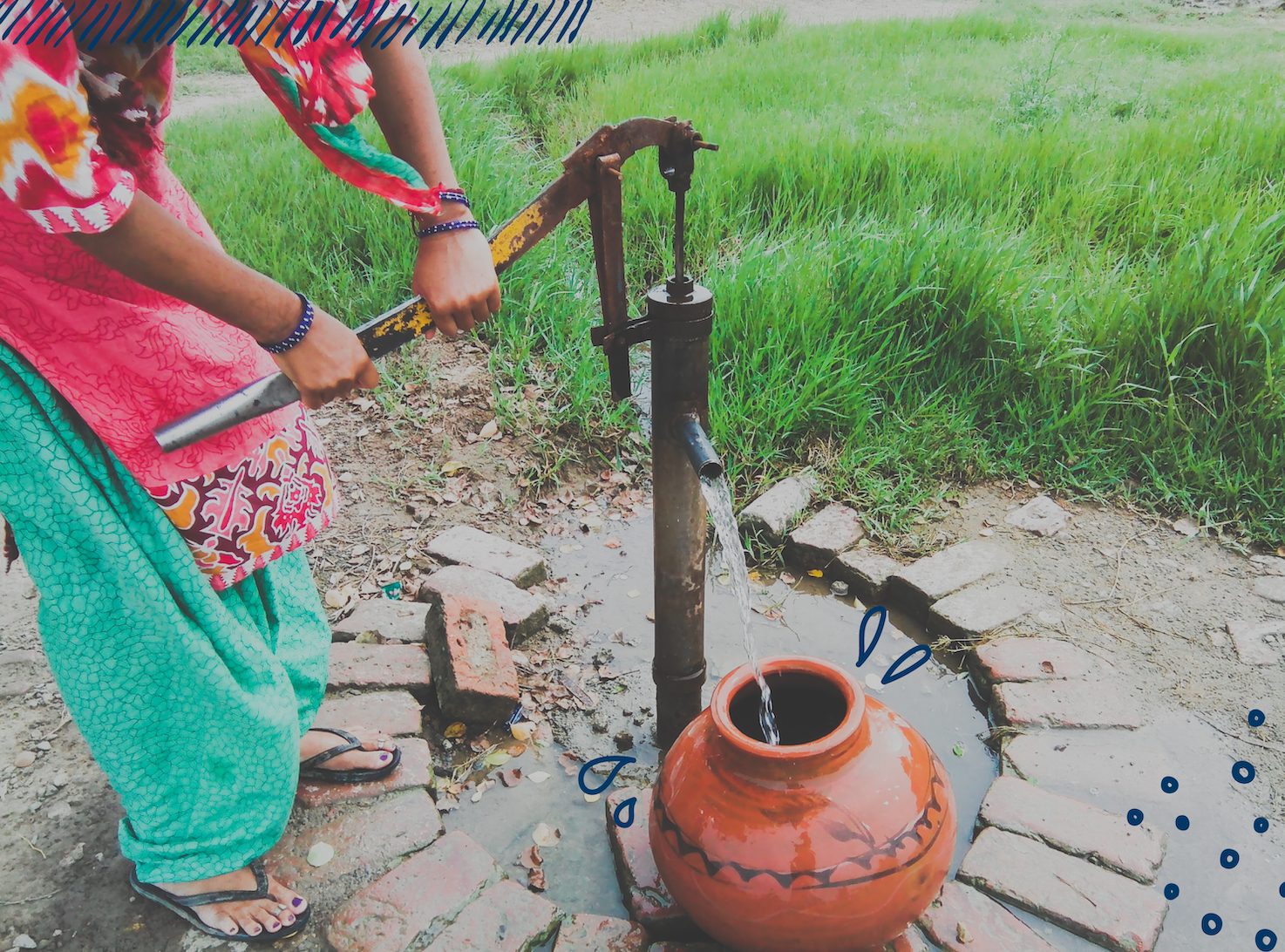 Woman fetching water from water pump