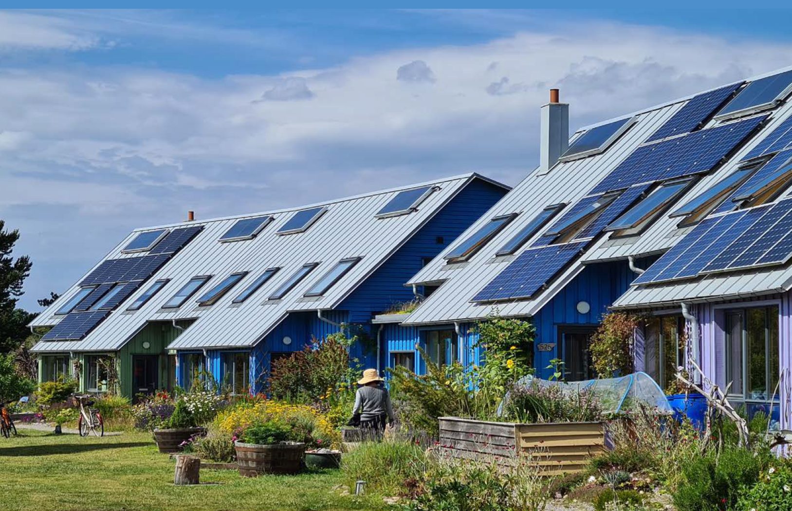 A row of houses with solar panels and backyard garden. Appeared in the cover of the IPCC report