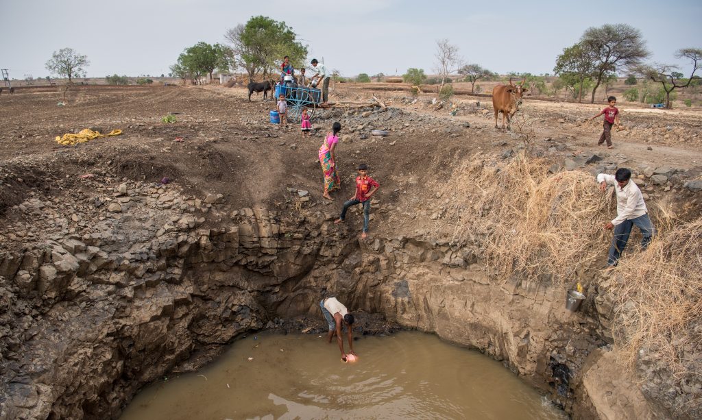 Villagers collecting water at the bottom of a well in drought prone Beed district.