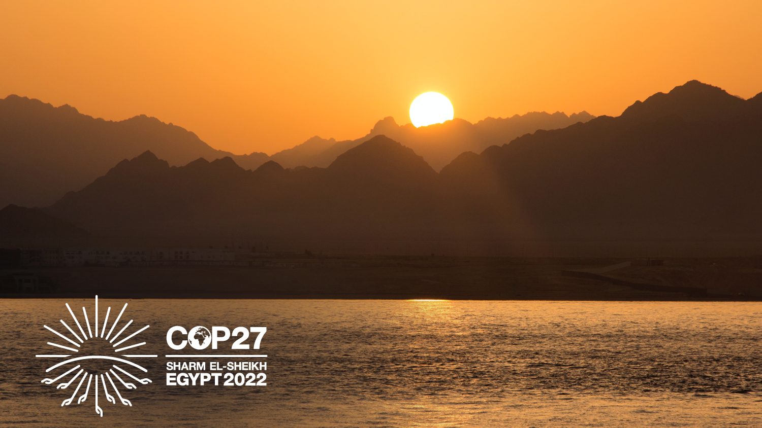 Sharm El-Sheikh, Qesm Sharm Ash Sheikh, Egypt - sun rising behind silhouettes of mountains overlooking a body of water