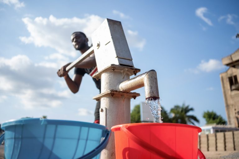 fresh water flowing from an African made borehole to bucket