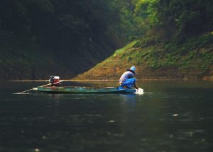 person fishing on a river