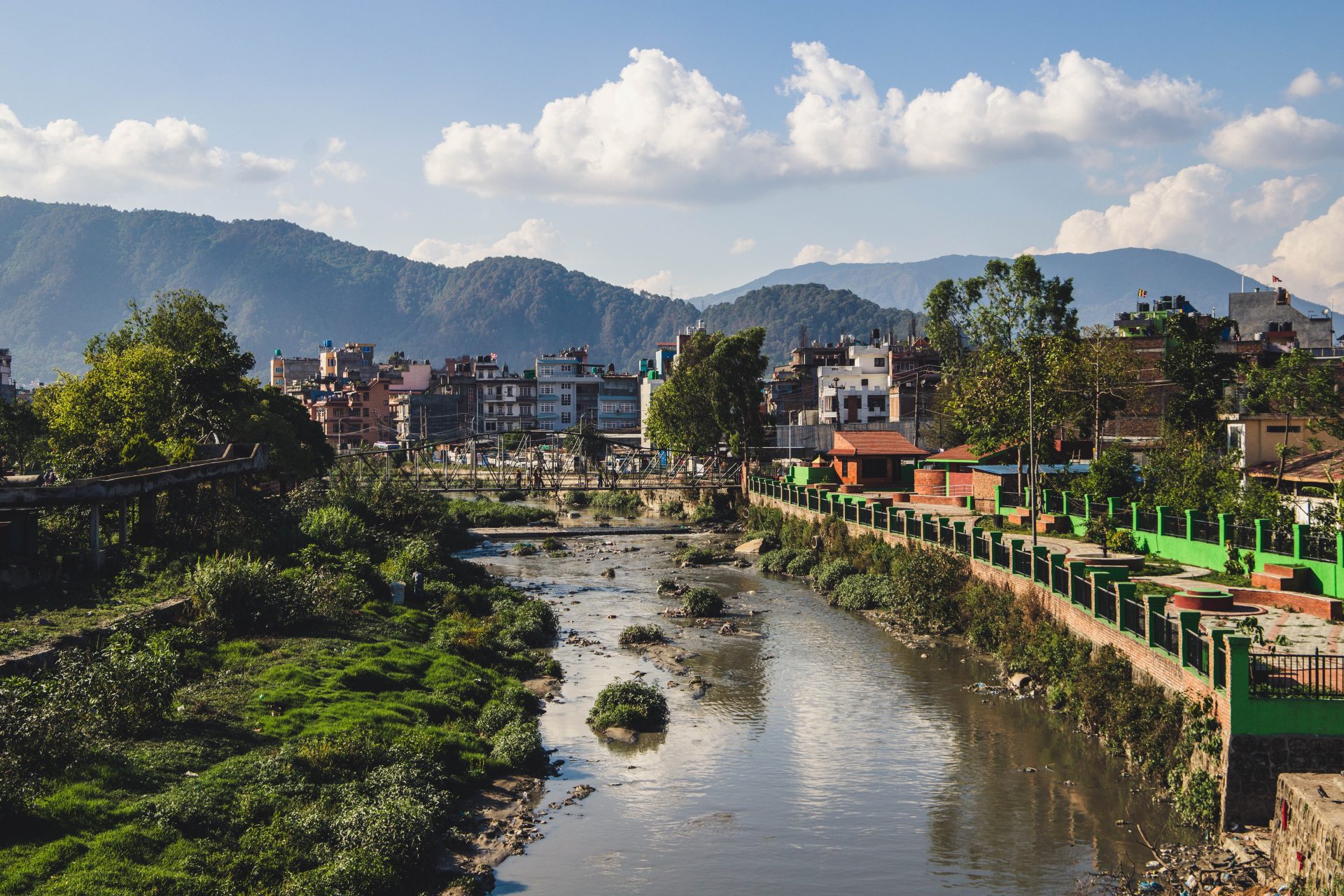 river in the city of Kathamndu with mountains in the background in a sunny and beautiful day - Nepal