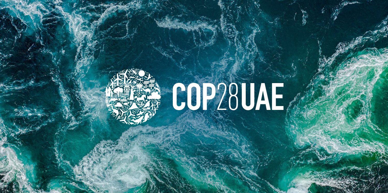 Swirly water from above, with turquoise, blue and white shades. COP28 UAE logo