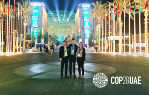 Ivan Sjögren, Manuel Eckert and Dani Gaillard-Picher standing in front of the Dubai City Expo at the closing of COP28, 2023