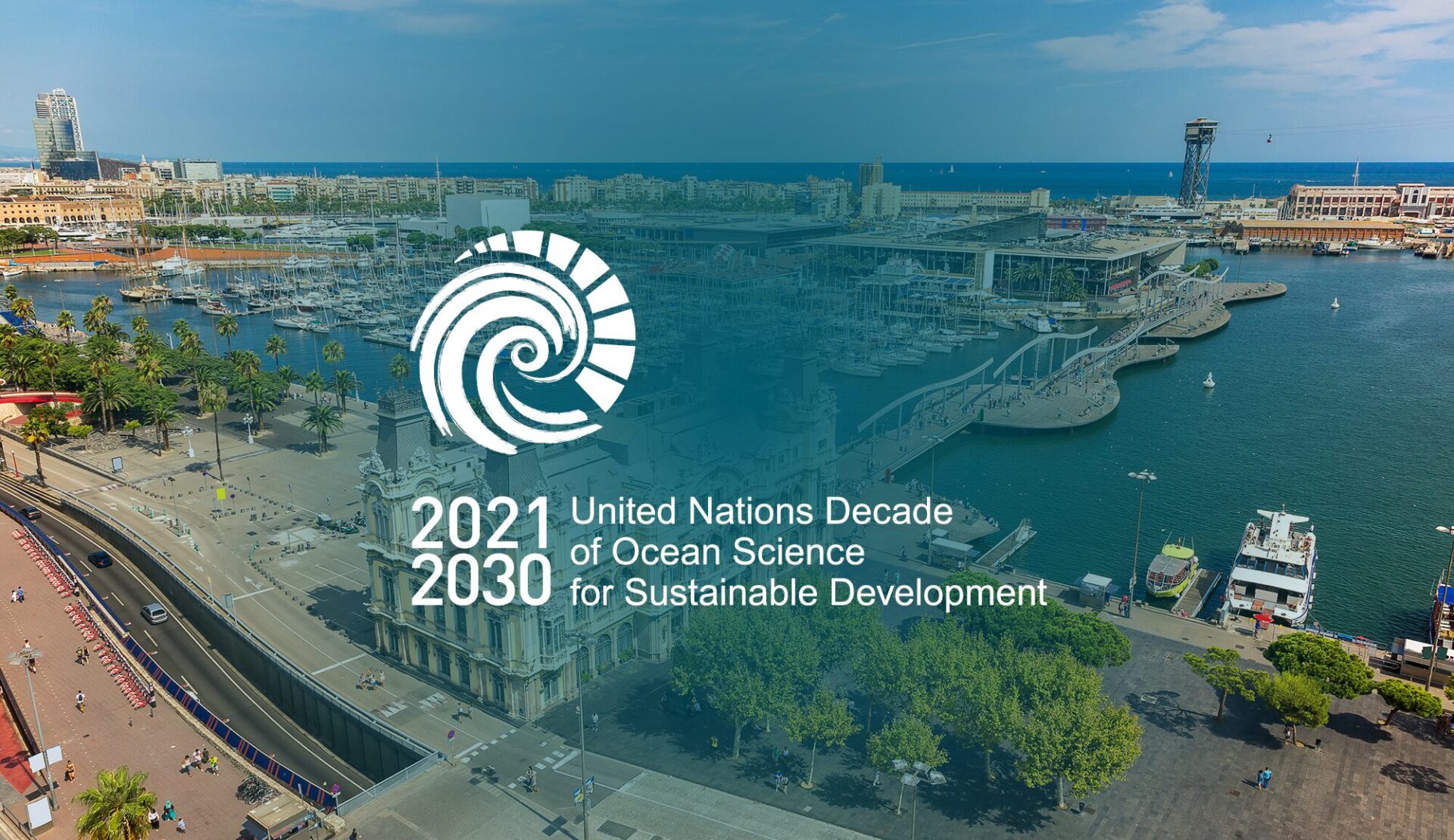 Aerial view of the City of Barcelona with the Mediteranean sea in the background. The logo of the Ocean Decade Conference on a dark teal overlay