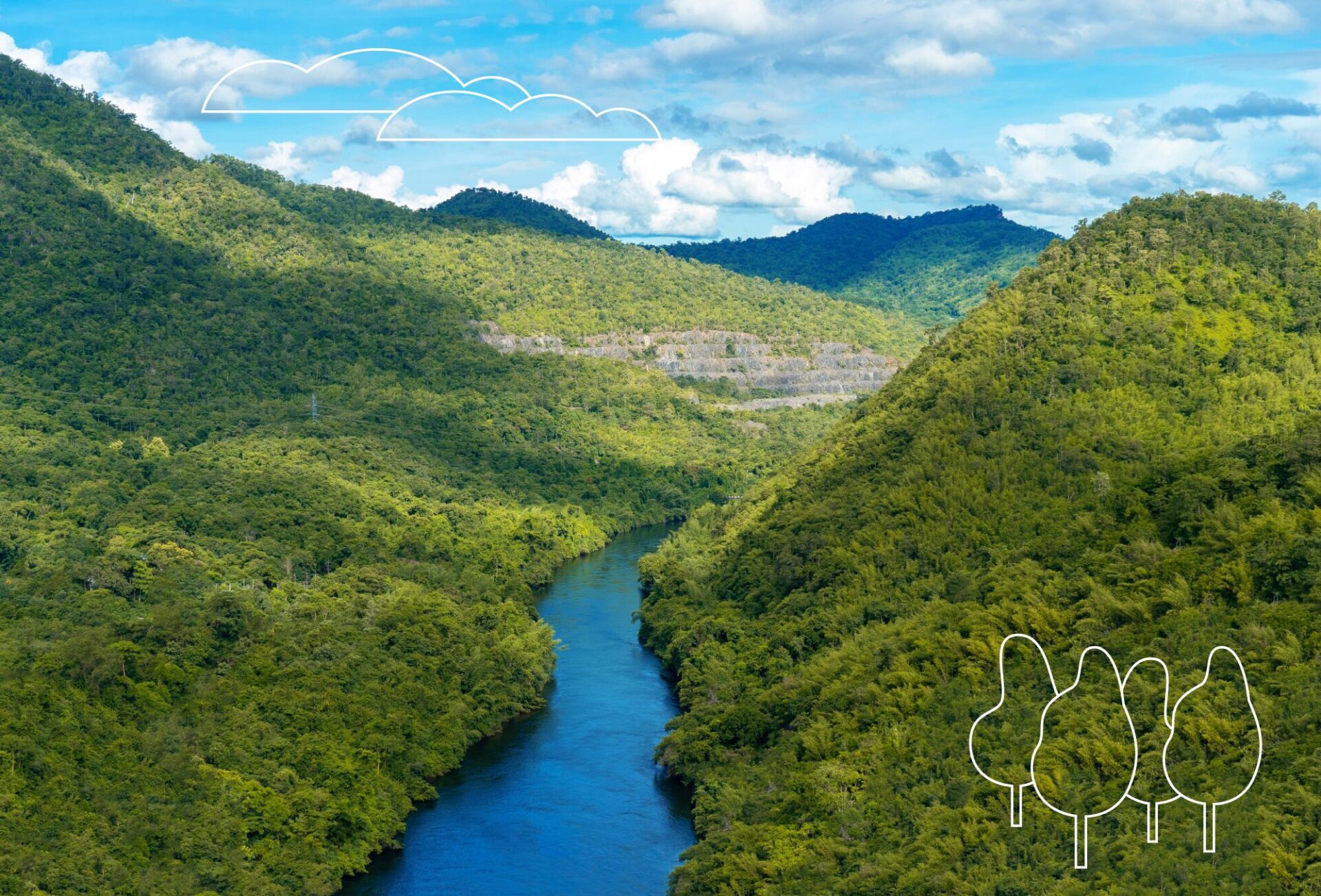 Aerial view of a river winding between 2 hills covered with forest. A bright blue cloudy sky on the horizon.