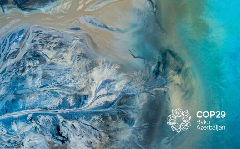 View from above, of surrealistic industrial place in shades of grey, turquoise and beige.